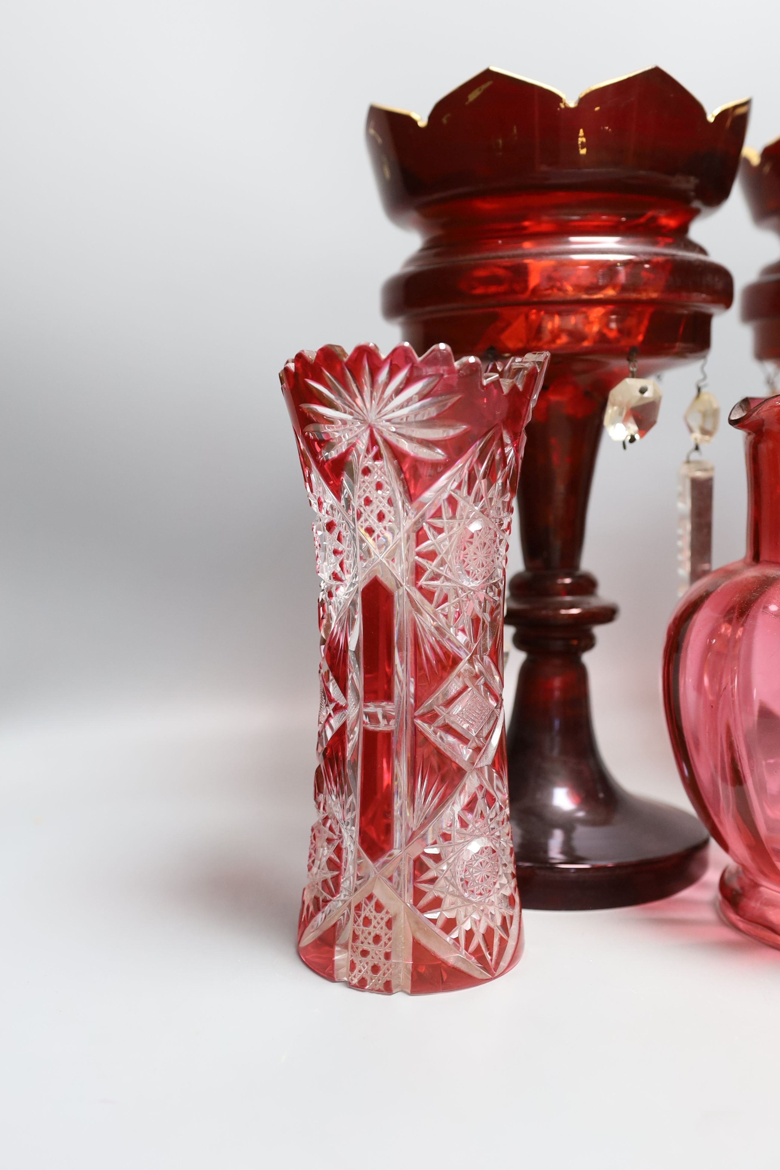 A pair of late 19th century ruby glass lustres, 30cm tall, cranberry jug, Bohemian vase and one other (5)
